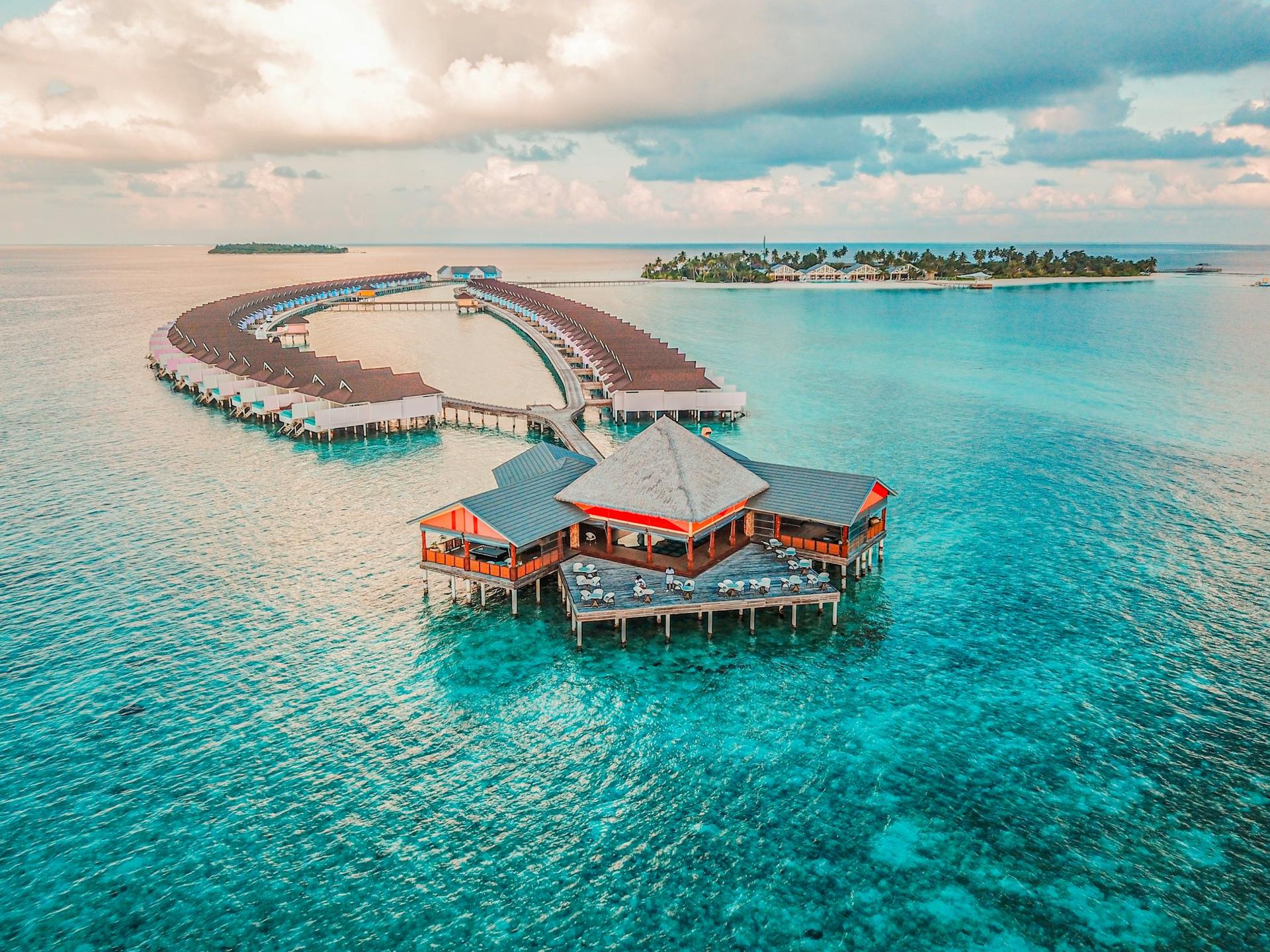 Overwater villas over a turquoise lagoon in the Maldives