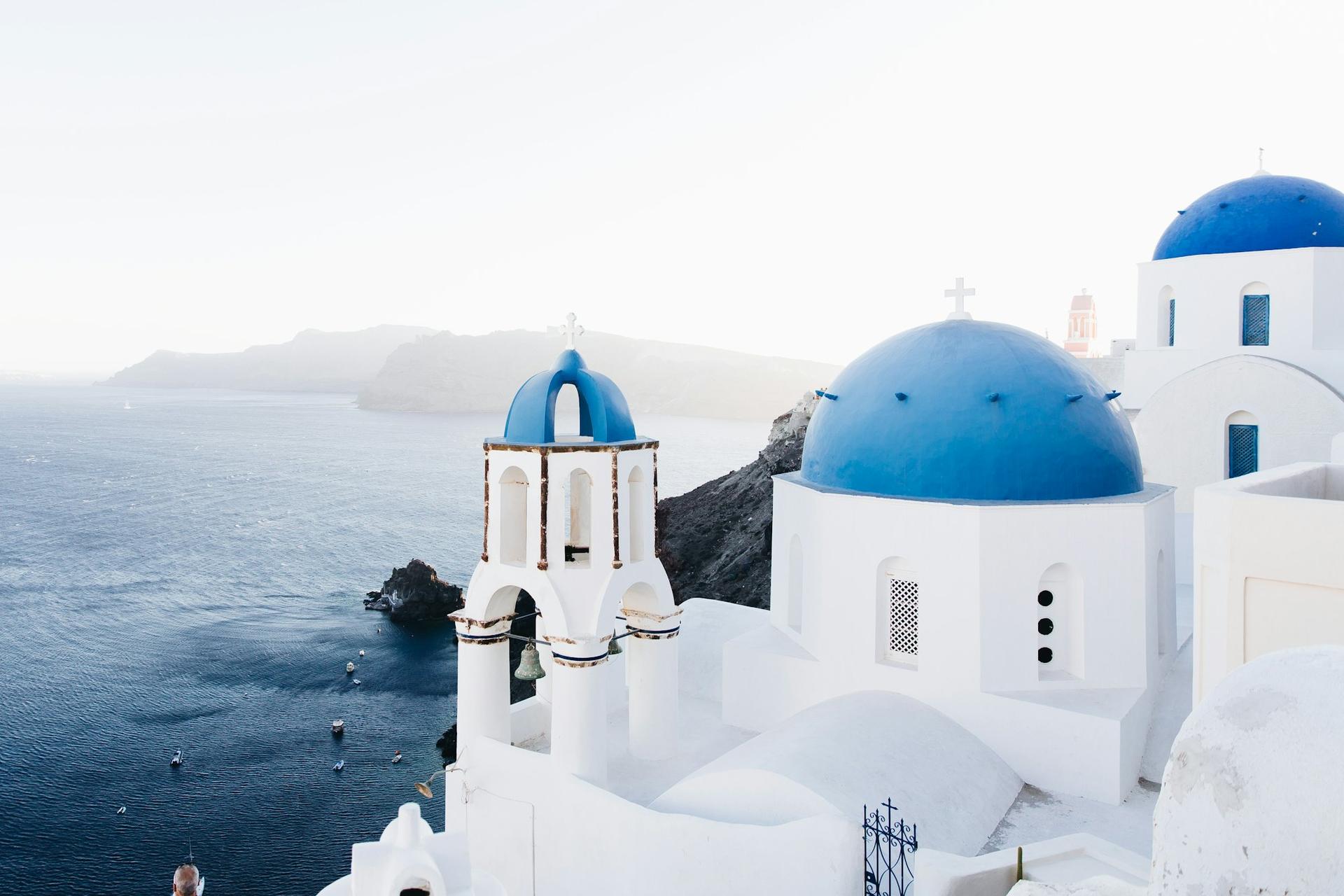 Whitewashed houses and blue domes above the sea in Santorini